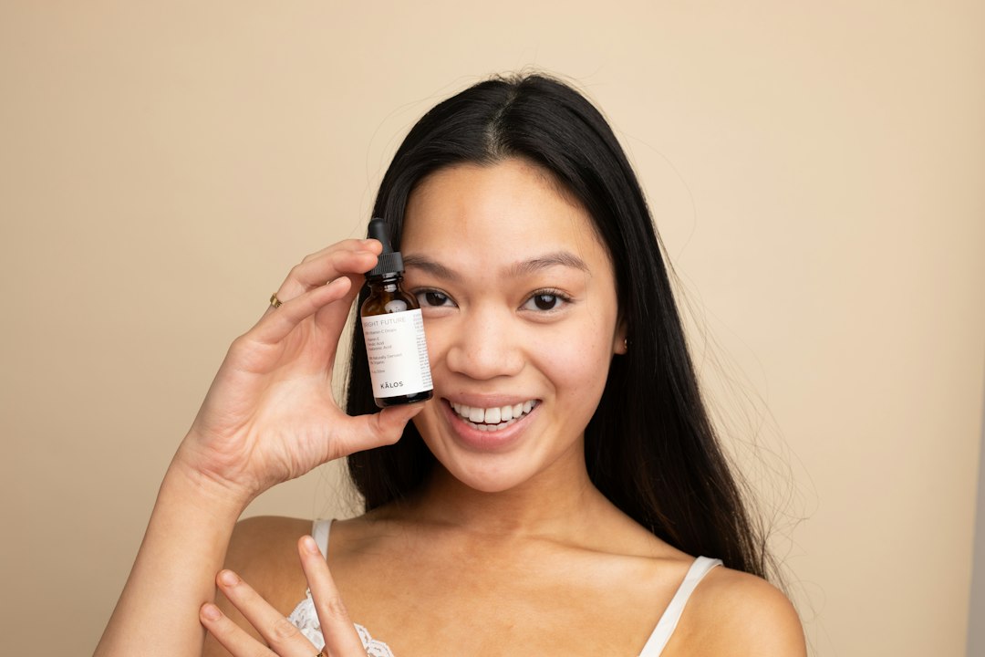 Woman applying hair oil to smooth and hydrate strands