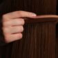 Woman practicing healthy hair care habits brushing hair