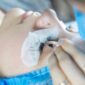 Lash lift vs lash extensions: young woman receiving treatment