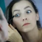 Woman applying makeup as part of her daily beauty routine