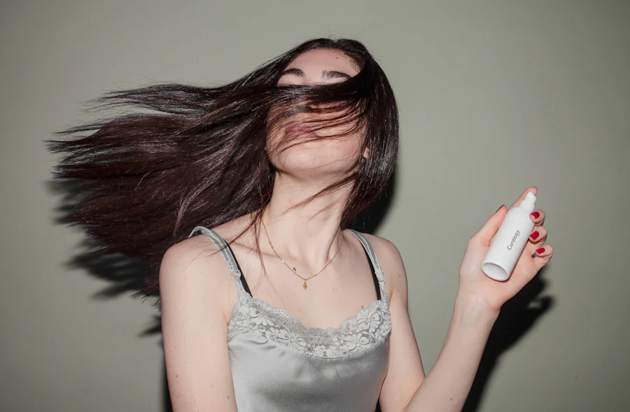 Woman holding a heat protectant spray bottle for keratin treatment aftercare