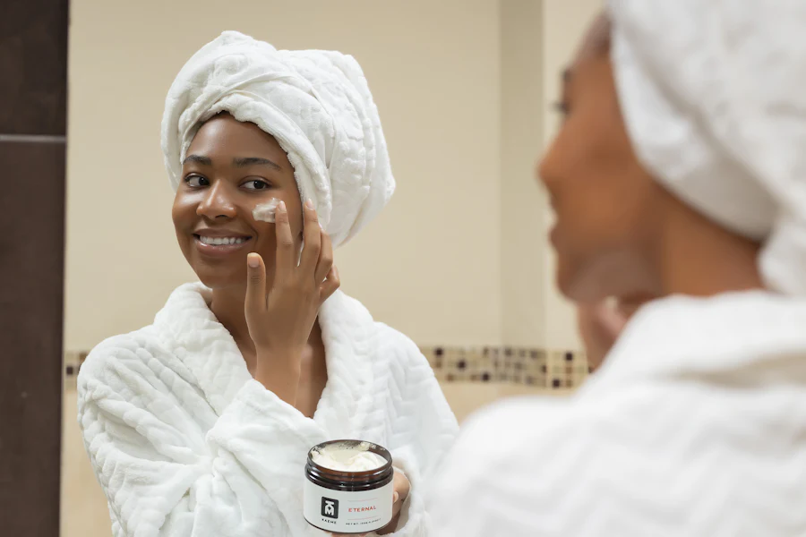 Woman with a jar of rich moisturizing cream on her face