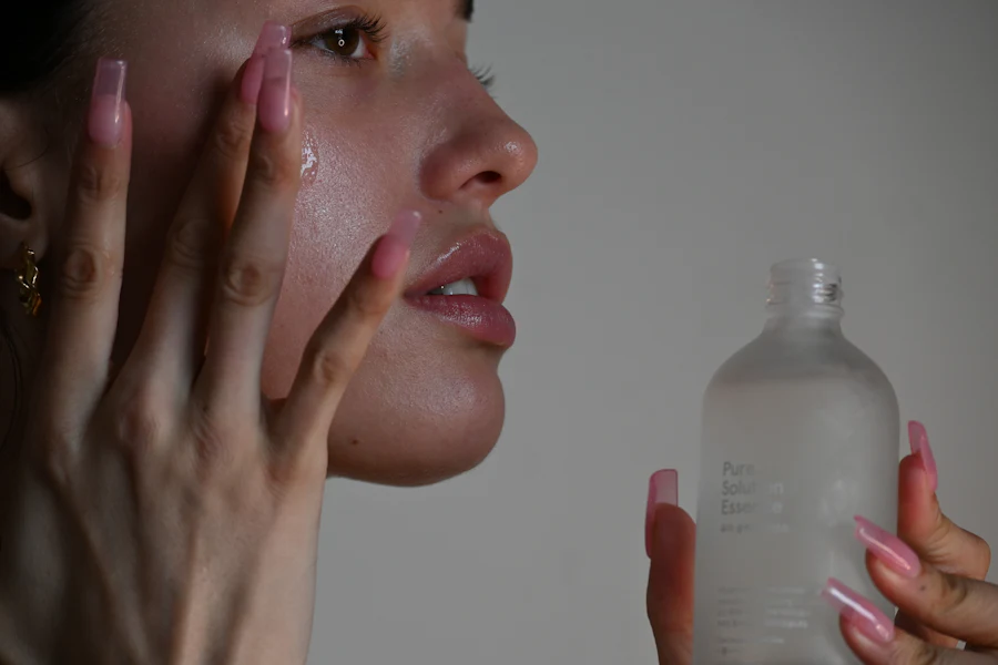 Woman applying a calming serum to her cheek after a skin treatment