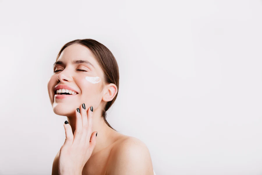 Smiling woman touching her smooth hydrated face
